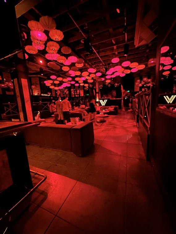 The same club floor under red house lighting