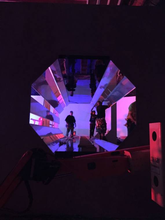 Faceted tunnel set, angular walls lit in colour