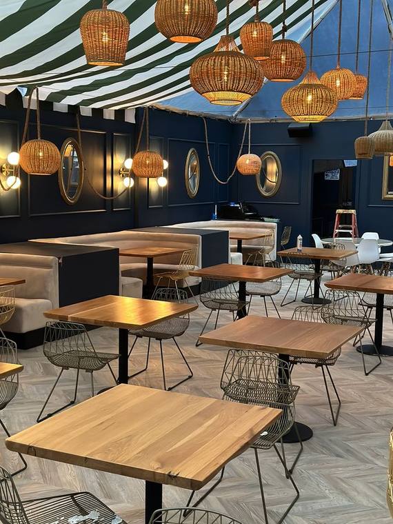 Covered restaurant patio: awning, herringbone deck and lighting