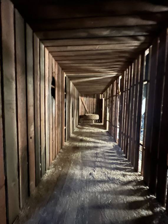 Timber prison corridor built in forced perspective