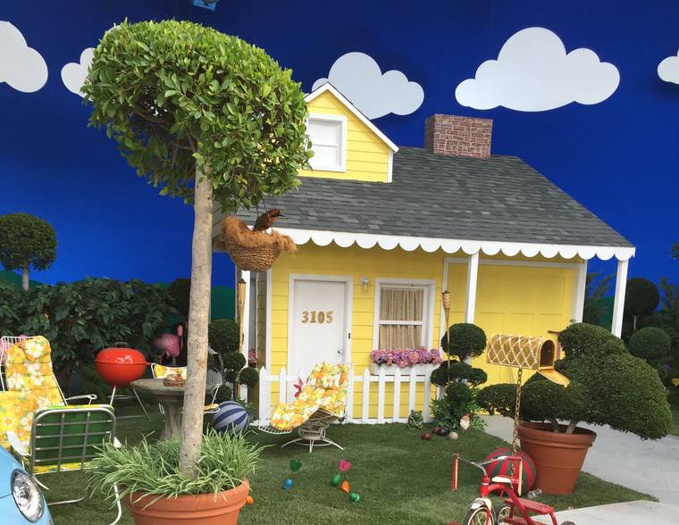 Corner house with sidewalk, lawn and street built on stage