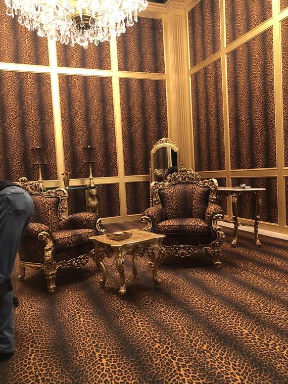 Panelled throne room set with gilt furniture